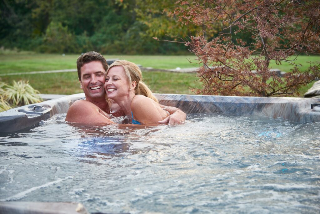 Picture of a couple enjoying their hot tub in a scenic setting